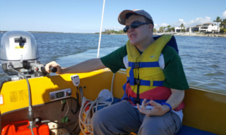 Mitchell steering a boat