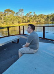 Mitchell sitting on a bench
