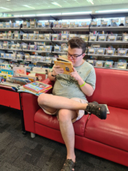 Mitchell sitting reading a book