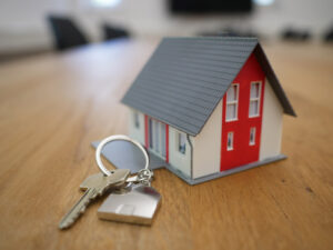 Toy house and door key on key ring